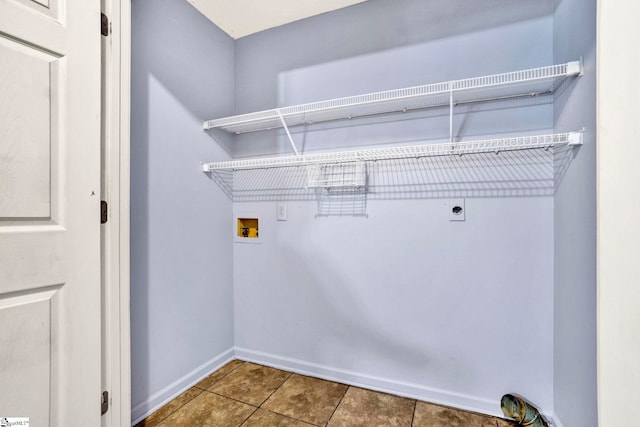 laundry room featuring hookup for a washing machine, hookup for an electric dryer, laundry area, baseboards, and tile patterned floors