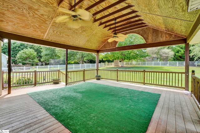 exterior space with a ceiling fan, a fenced backyard, and a yard