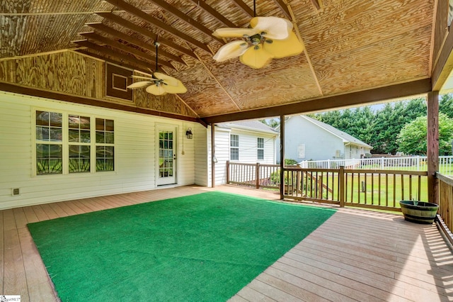 wooden terrace featuring a lawn, fence, and a ceiling fan