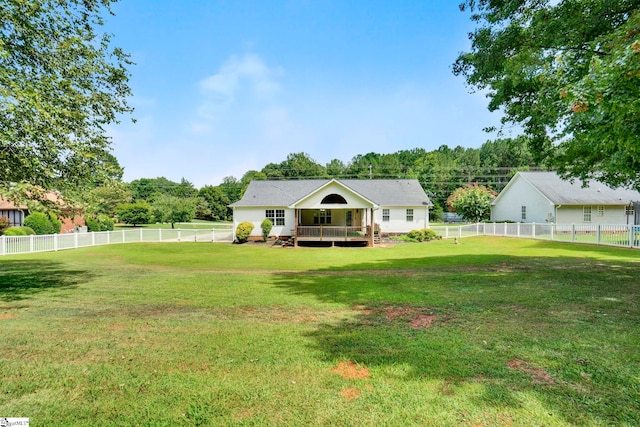 rear view of property featuring a deck, a yard, and a fenced backyard