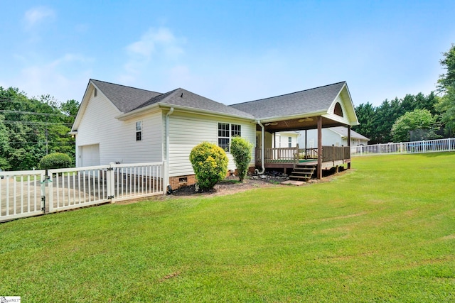 back of property featuring a yard, a shingled roof, crawl space, fence, and a deck