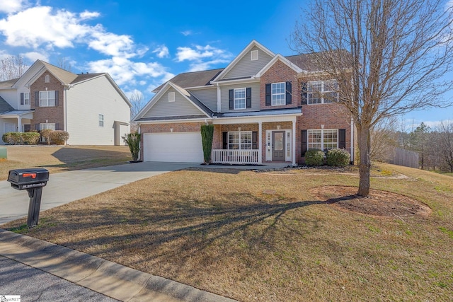 view of front facade with driveway, covered porch, a front yard, and brick siding