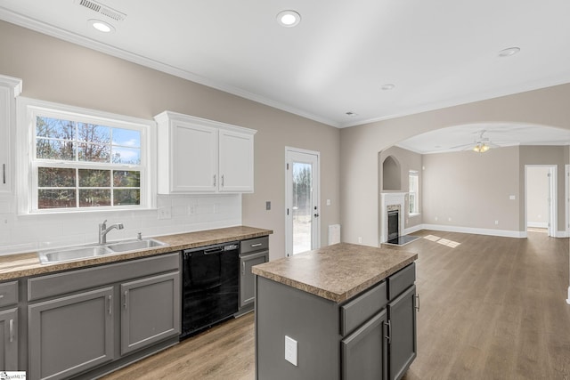 kitchen with dishwasher, a sink, gray cabinets, and visible vents