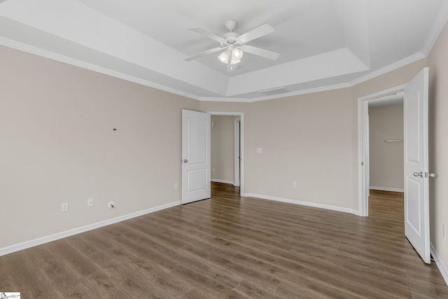 unfurnished room with a ceiling fan, a raised ceiling, baseboards, and wood finished floors