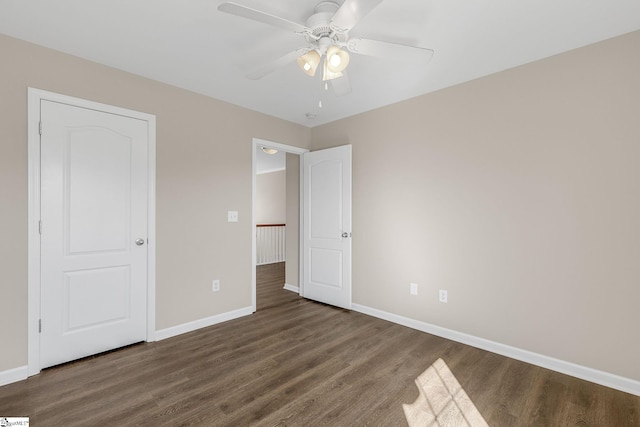 unfurnished bedroom with ceiling fan, baseboards, and wood finished floors