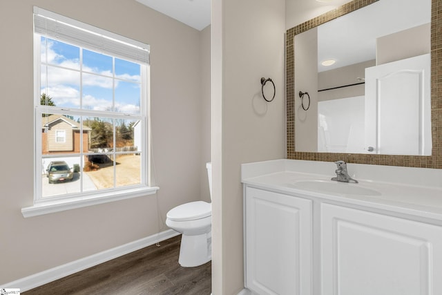 full bathroom with baseboards, vanity, toilet, and wood finished floors