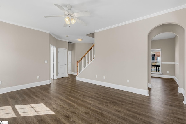 empty room with ornamental molding, arched walkways, stairway, and dark wood-style floors