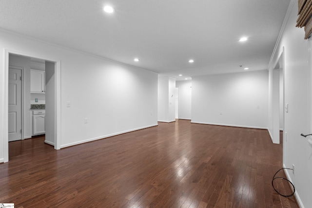 unfurnished room with baseboards, dark wood finished floors, and recessed lighting