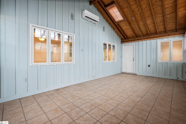 unfurnished sunroom with vaulted ceiling with skylight, a wall mounted air conditioner, and wooden ceiling