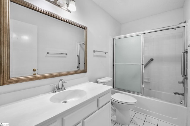 bathroom with tile patterned flooring, vanity, toilet, and bath / shower combo with glass door