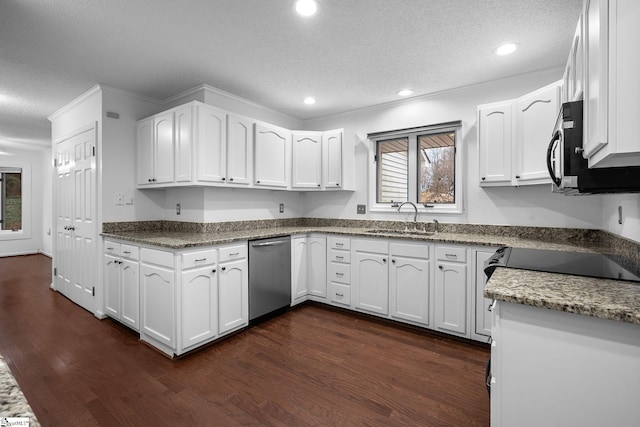 kitchen featuring a textured ceiling, dark wood-style flooring, a sink, and white cabinets