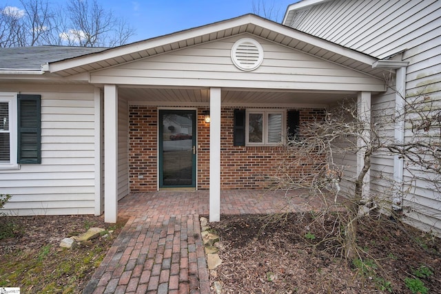 entrance to property with brick siding