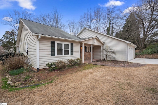 single story home featuring covered porch, concrete driveway, an attached garage, and a front yard