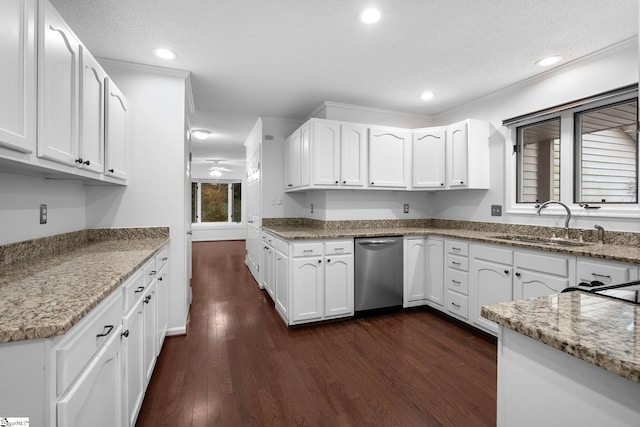 kitchen featuring dark wood finished floors, dishwasher, a textured ceiling, white cabinetry, and a sink