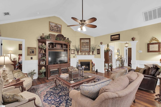 living room with arched walkways, wood finished floors, visible vents, and a ceiling fan