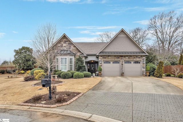 view of front of property featuring concrete driveway, an attached garage, a standing seam roof, metal roof, and stone siding