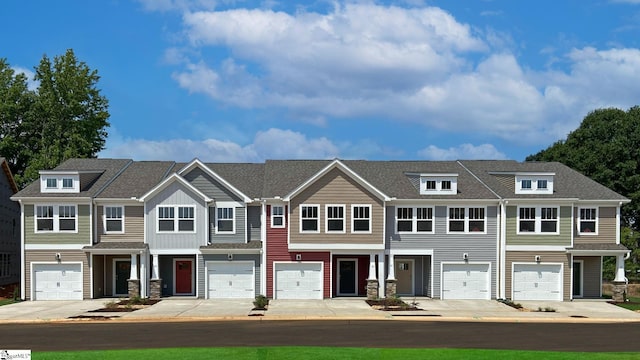 townhome / multi-family property featuring a garage and driveway