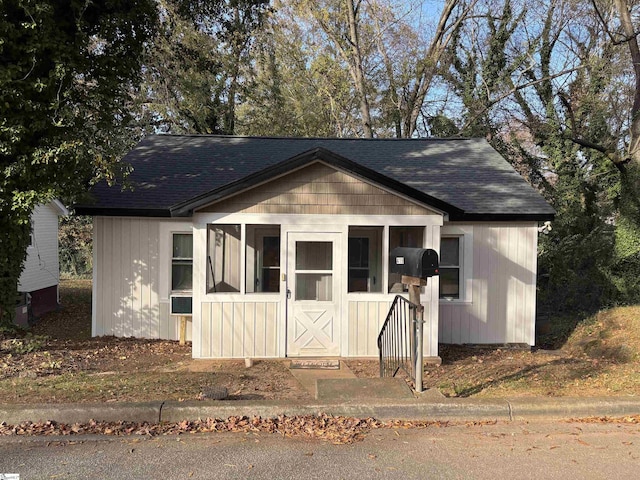 bungalow-style home with a shingled roof