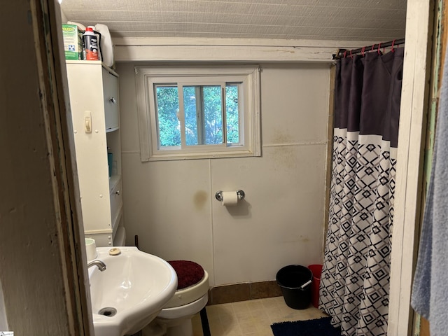 full bath with a sink and a shower with shower curtain