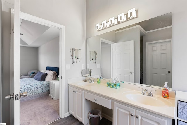 bathroom with a sink, ensuite bath, and double vanity