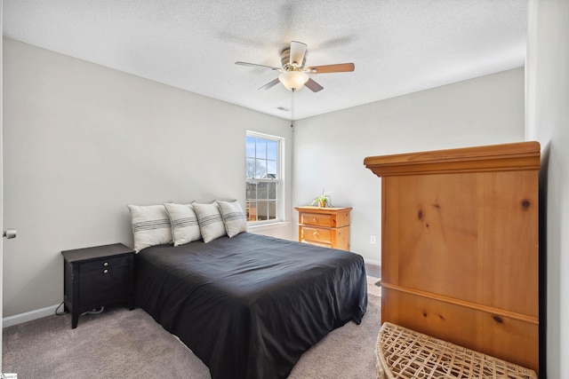 bedroom featuring a textured ceiling, carpet flooring, a ceiling fan, and baseboards