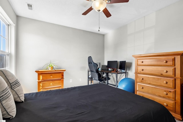 bedroom featuring ceiling fan and visible vents