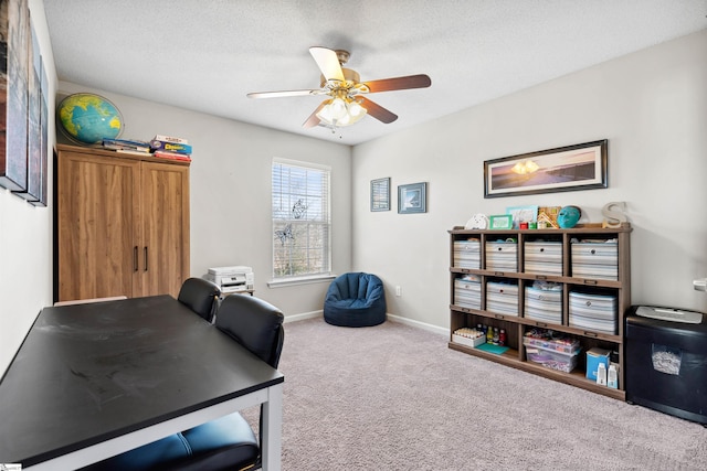 office space with a textured ceiling, carpet, a ceiling fan, and baseboards