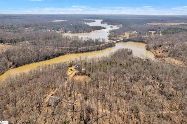 aerial view featuring a water view and a wooded view