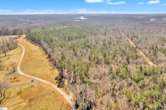 birds eye view of property featuring a view of trees