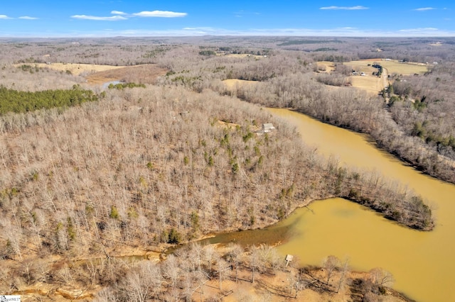 bird's eye view with a water view and a forest view