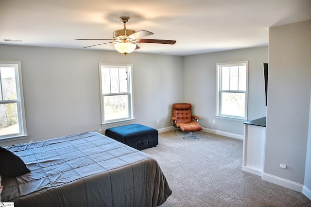 carpeted bedroom featuring baseboards, visible vents, and ceiling fan