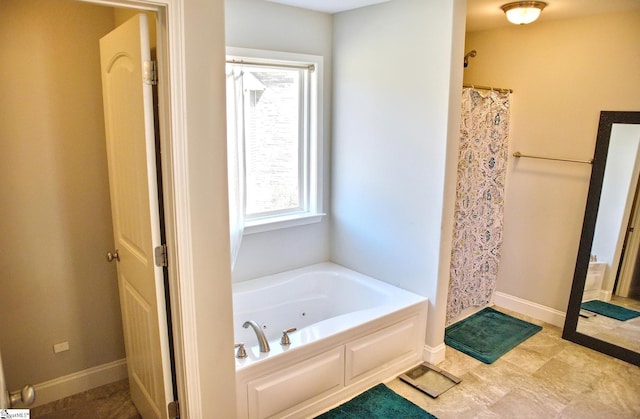 full bathroom with baseboards, a tub with jets, and curtained shower