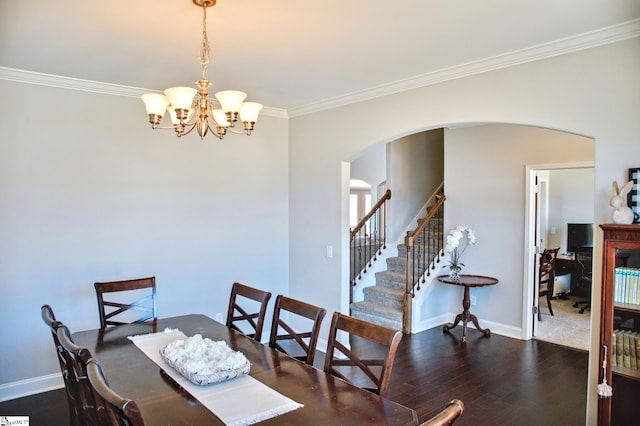 dining space with baseboards, arched walkways, stairway, ornamental molding, and wood finished floors