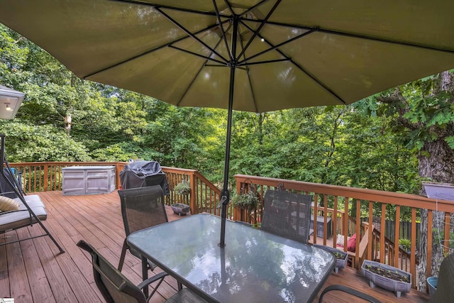 wooden terrace with outdoor dining area and grilling area