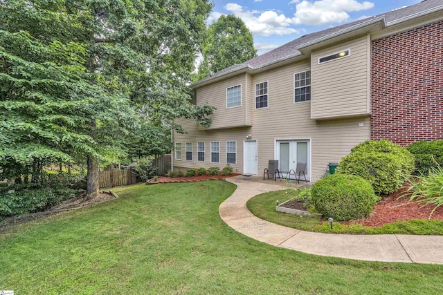 back of house with a patio, a lawn, and fence