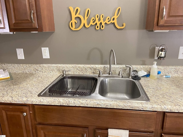 kitchen featuring brown cabinetry and a sink