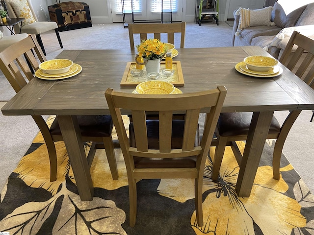 dining space with light colored carpet