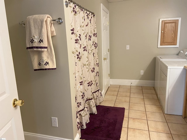 full bath with a shower with shower curtain, baseboards, separate washer and dryer, and tile patterned floors