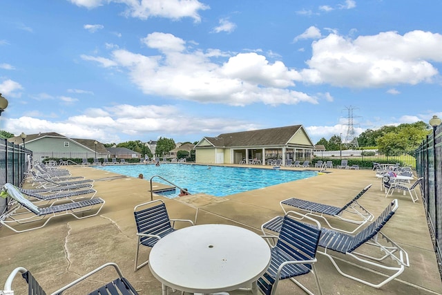 community pool featuring a patio and fence