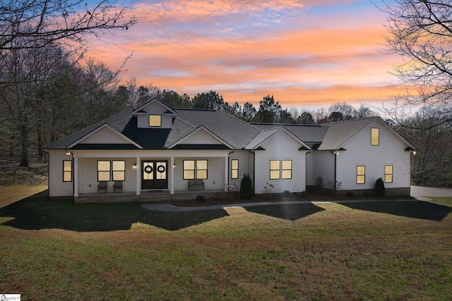 view of front of house featuring a porch and a yard