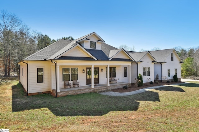 view of front of house featuring crawl space, a porch, a front lawn, and roof with shingles