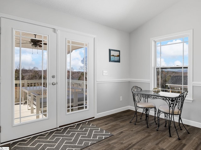 dining area featuring dark wood-style floors, baseboards, vaulted ceiling, and a ceiling fan