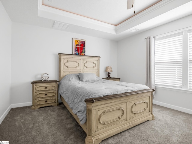 bedroom with baseboards, a tray ceiling, and light colored carpet