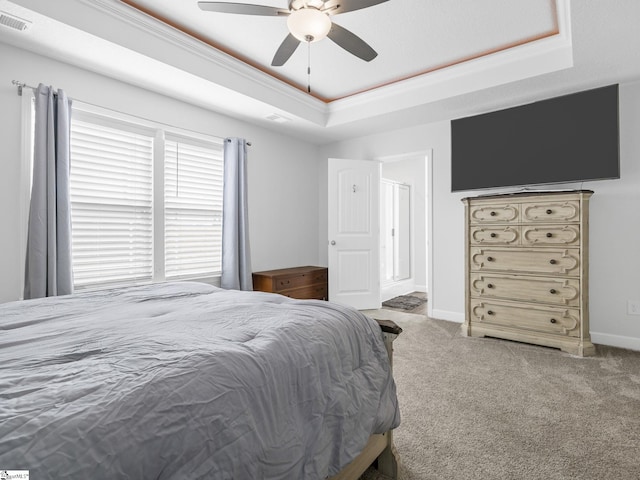 bedroom featuring carpet, visible vents, a raised ceiling, and baseboards