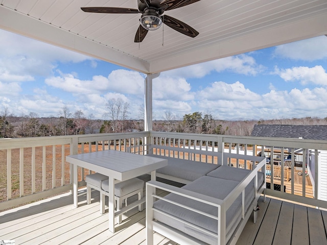 wooden deck featuring a ceiling fan