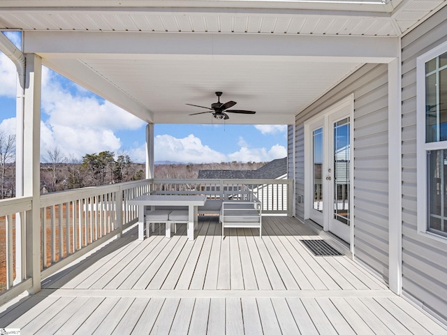 wooden deck featuring a ceiling fan and french doors