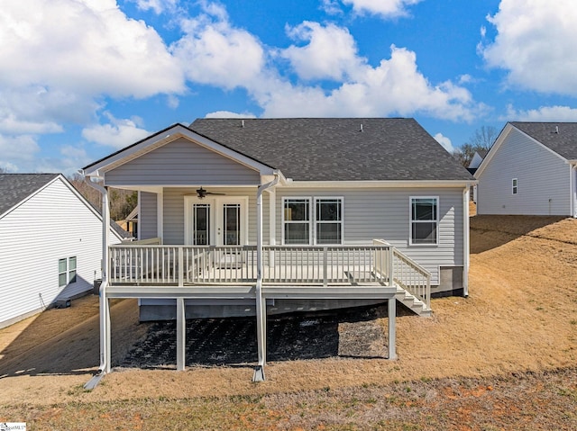 rear view of house with french doors, roof with shingles, ceiling fan, and a deck