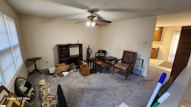 interior space featuring carpet and a ceiling fan