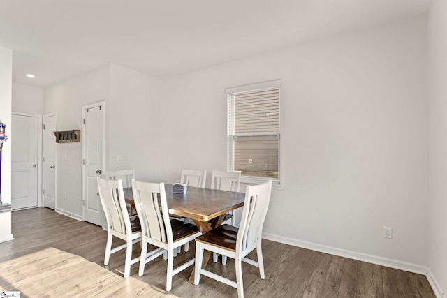 dining room with recessed lighting, wood finished floors, and baseboards