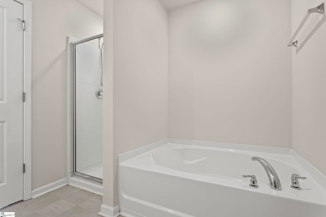 bathroom with a garden tub and a stall shower